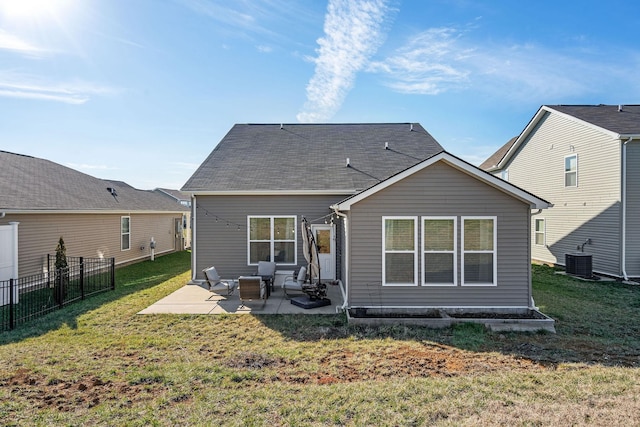 back of house featuring cooling unit, a patio area, a lawn, and fence