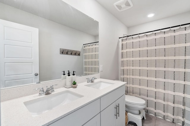 full bath featuring toilet, double vanity, visible vents, and a sink