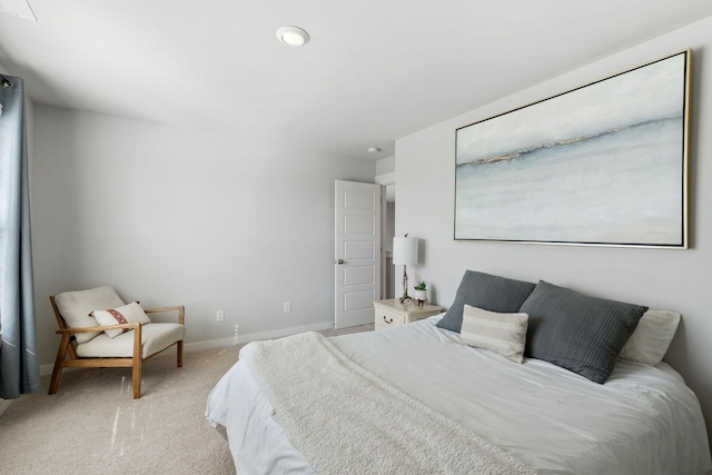 bedroom featuring baseboards and light colored carpet