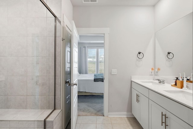 ensuite bathroom with visible vents, tiled shower, ensuite bath, tile patterned flooring, and a sink