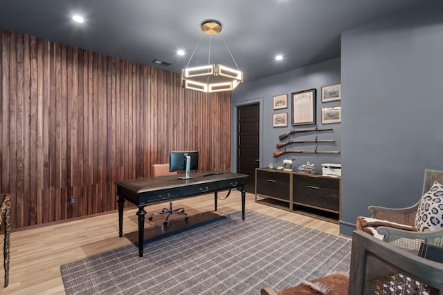 office featuring wood walls, visible vents, wood finished floors, and recessed lighting