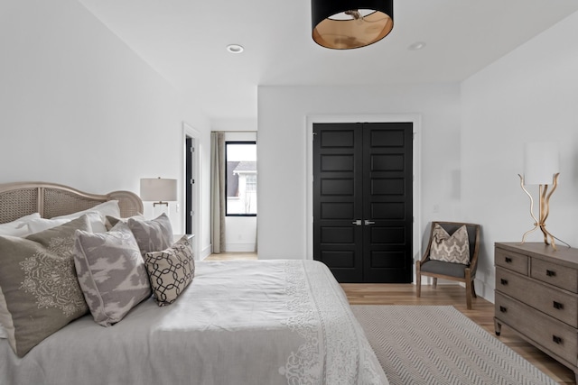 bedroom with recessed lighting and wood finished floors