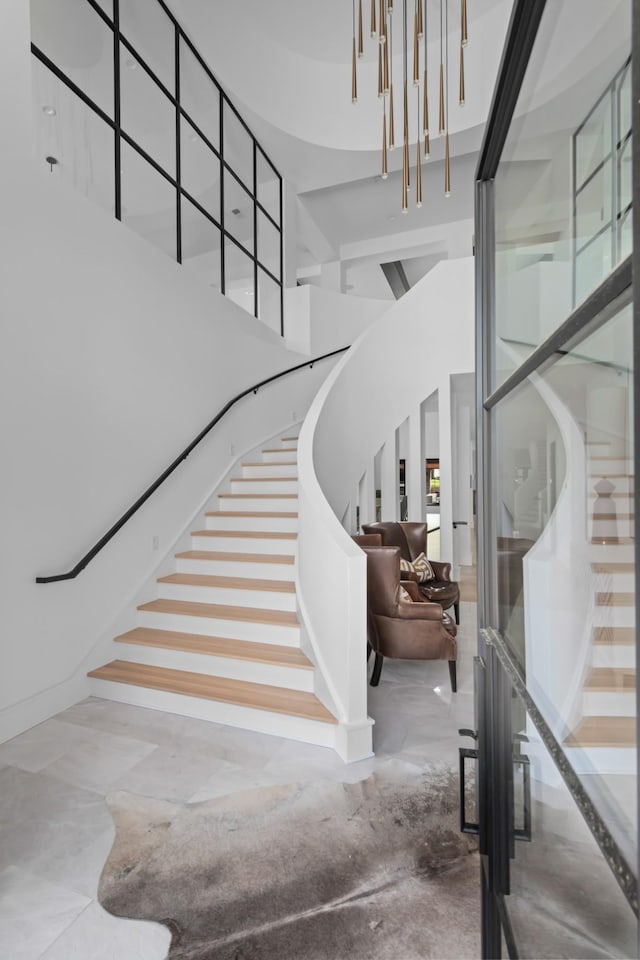 stairs featuring a towering ceiling