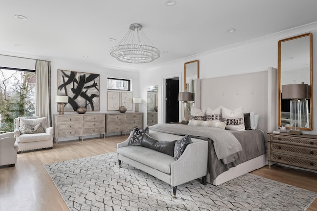 bedroom featuring crown molding, multiple windows, and wood finished floors