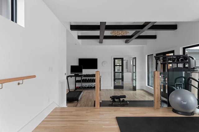 workout room with coffered ceiling, wood finished floors, and baseboards