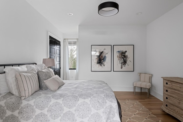 bedroom with recessed lighting, baseboards, and wood finished floors