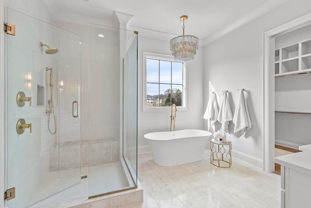 bathroom featuring crown molding, a stall shower, a freestanding tub, and baseboards