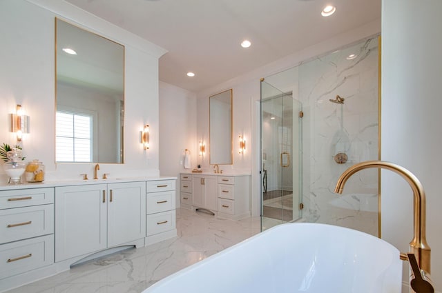 full bath featuring a marble finish shower, marble finish floor, a freestanding bath, a sink, and recessed lighting