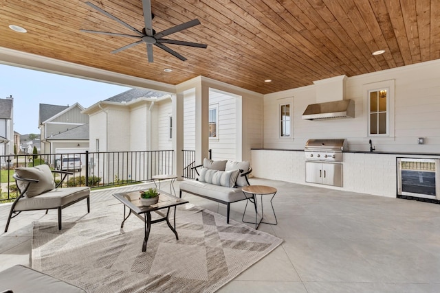 view of patio featuring wine cooler, grilling area, area for grilling, a ceiling fan, and an outdoor living space