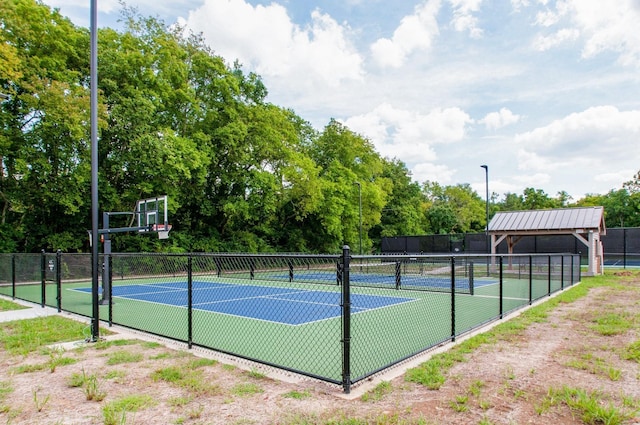 view of basketball court featuring a tennis court, community basketball court, and fence