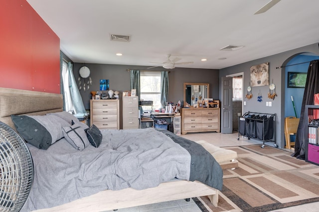 bedroom featuring ceiling fan, arched walkways, visible vents, and recessed lighting