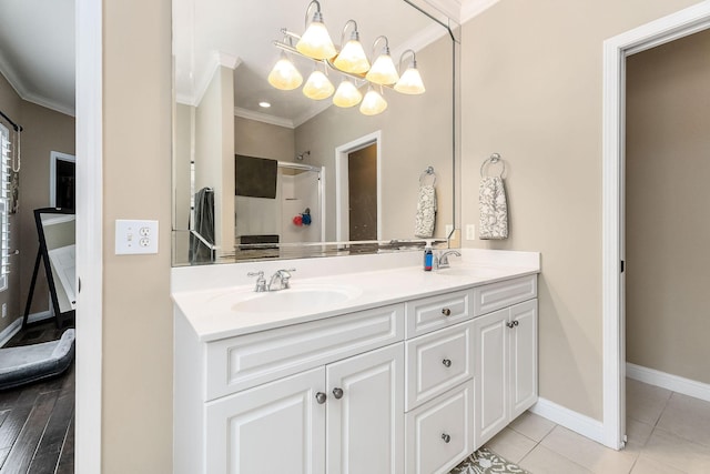 bathroom featuring ornamental molding, a notable chandelier, a sink, and an enclosed shower