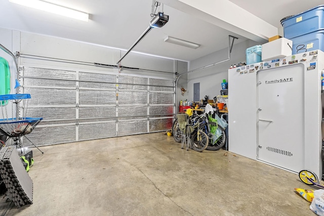 garage featuring electric panel and a garage door opener