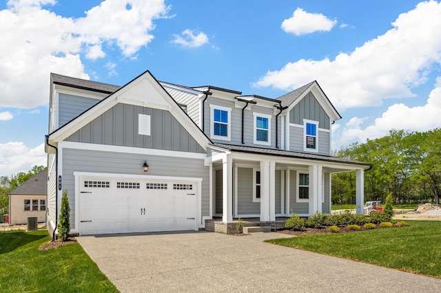 view of front of home featuring concrete driveway, an attached garage, a porch, board and batten siding, and a front yard