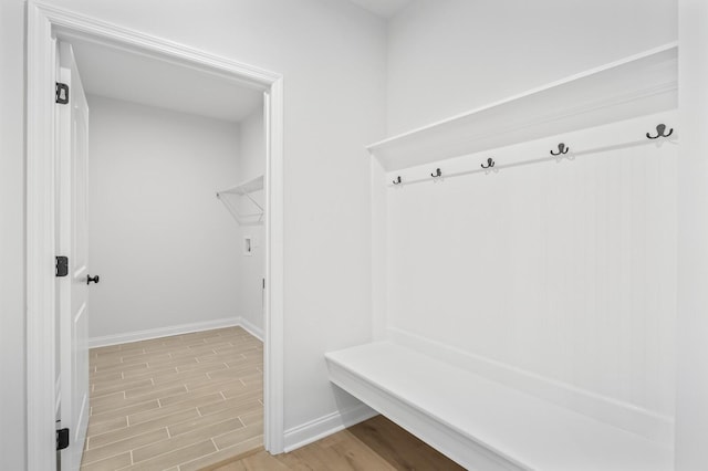 mudroom featuring light wood-type flooring and baseboards