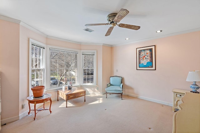 sitting room with light carpet, baseboards, visible vents, a ceiling fan, and ornamental molding