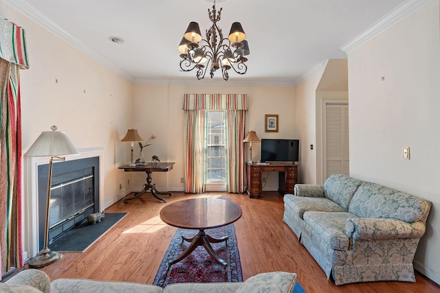 living room with a fireplace with flush hearth, light wood-type flooring, crown molding, and baseboards