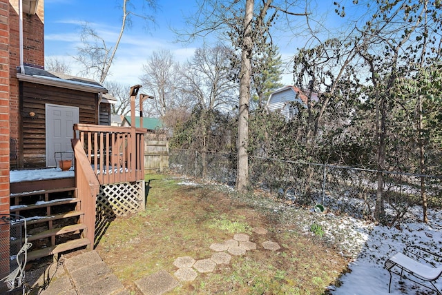 yard layered in snow with stairway, a fenced backyard, and a deck