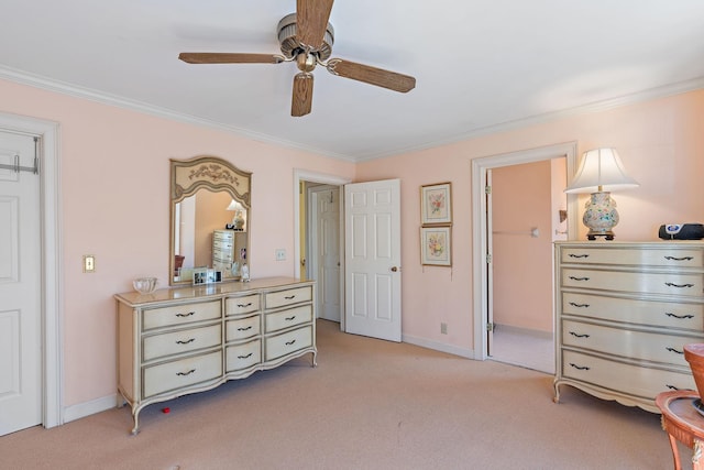 bedroom with ornamental molding, light colored carpet, and baseboards