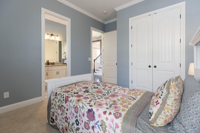 bedroom featuring crown molding, a closet, light carpet, ensuite bath, and baseboards