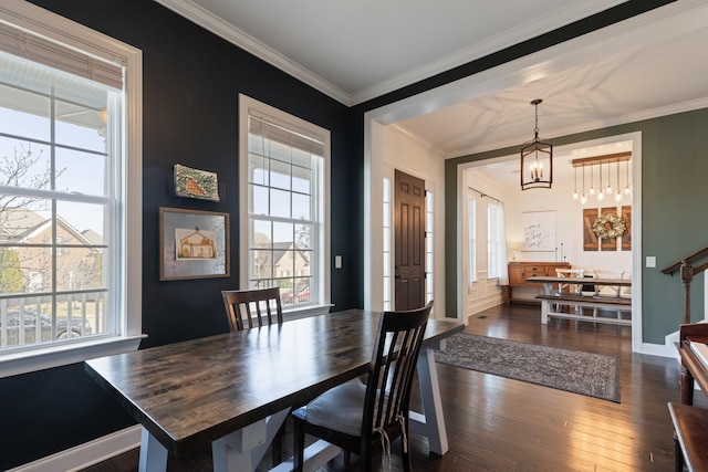 dining room featuring baseboards, stairway, dark wood-type flooring, crown molding, and a notable chandelier