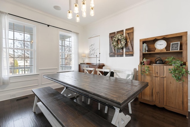 dining space with ornamental molding, a wealth of natural light, visible vents, and dark wood-type flooring