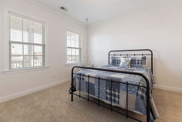 bedroom with carpet floors, visible vents, crown molding, and baseboards