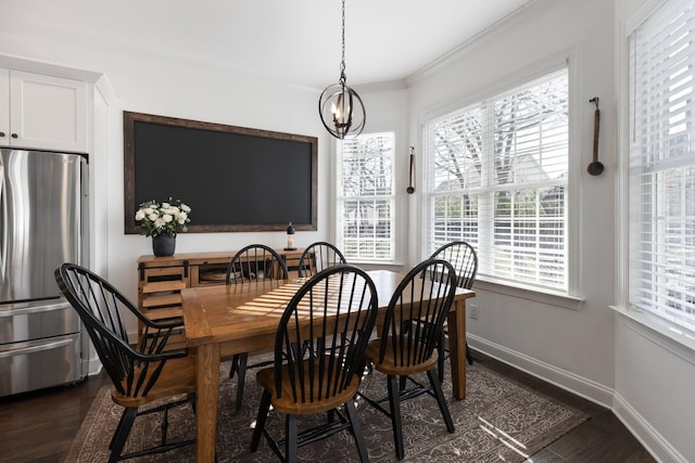 dining room featuring a notable chandelier, baseboards, dark wood-style flooring, and ornamental molding