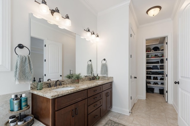 full bathroom with a sink, double vanity, a walk in closet, and crown molding