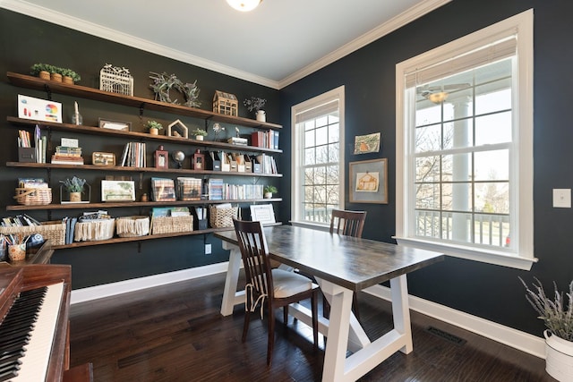 dining space featuring crown molding, visible vents, dark wood finished floors, and baseboards