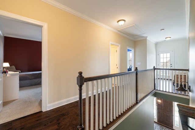 corridor featuring ornamental molding, baseboards, dark wood-type flooring, and an upstairs landing