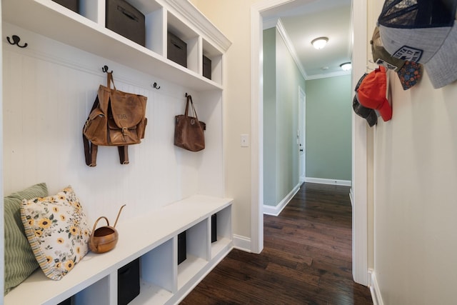 mudroom featuring ornamental molding, dark wood finished floors, and baseboards