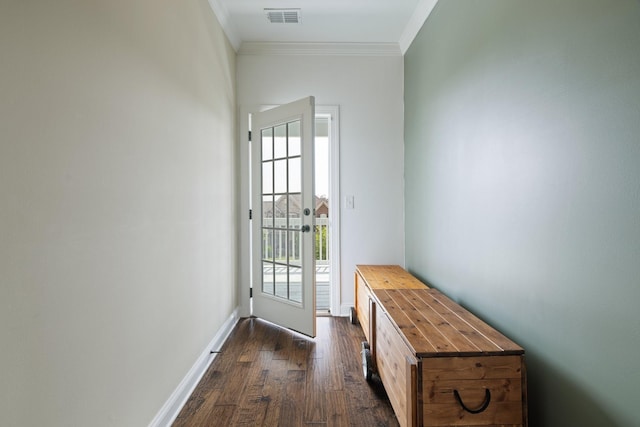 doorway to outside with ornamental molding, dark wood finished floors, visible vents, and baseboards