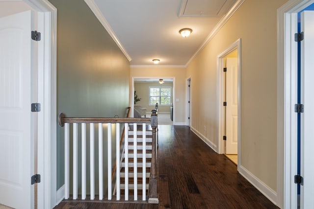 hallway with ornamental molding, dark wood finished floors, an upstairs landing, and baseboards