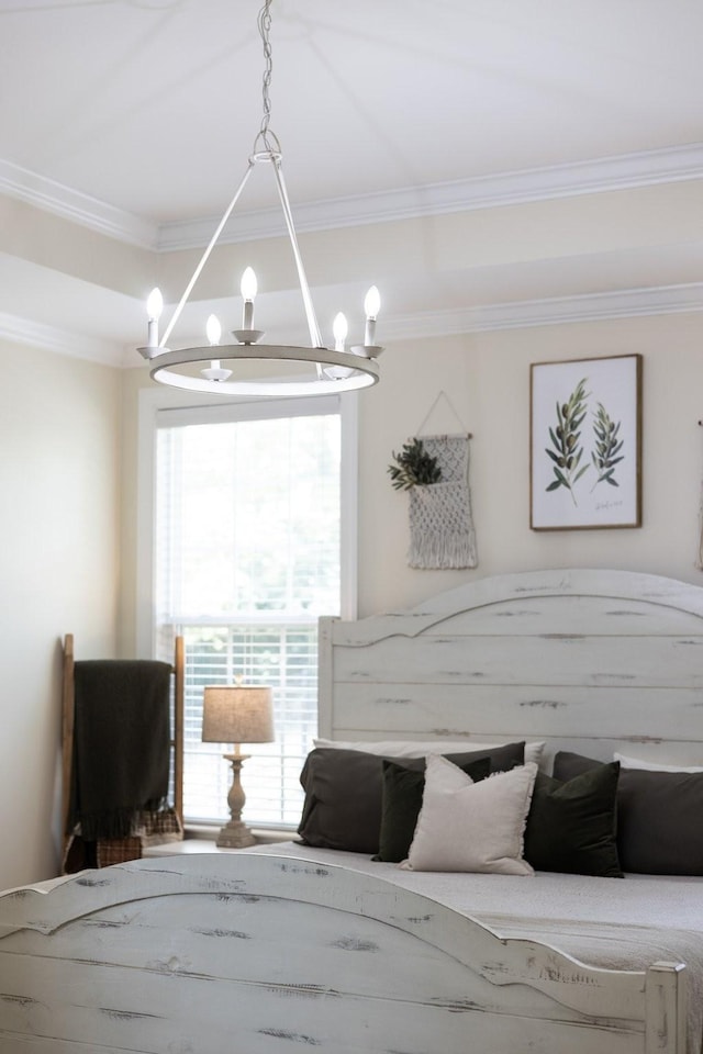 bedroom with an inviting chandelier and crown molding