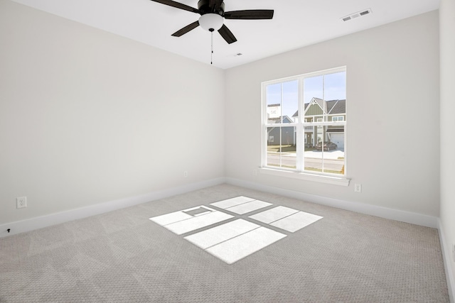 unfurnished room featuring carpet, visible vents, ceiling fan, and baseboards