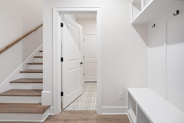 mudroom featuring light wood-style flooring and baseboards