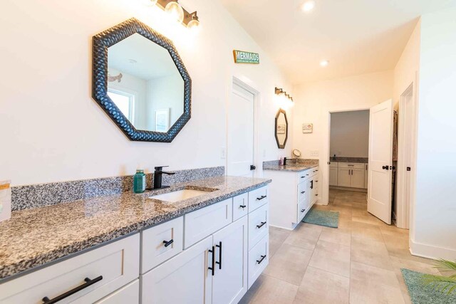 full bath featuring recessed lighting, two vanities, a sink, and tile patterned floors