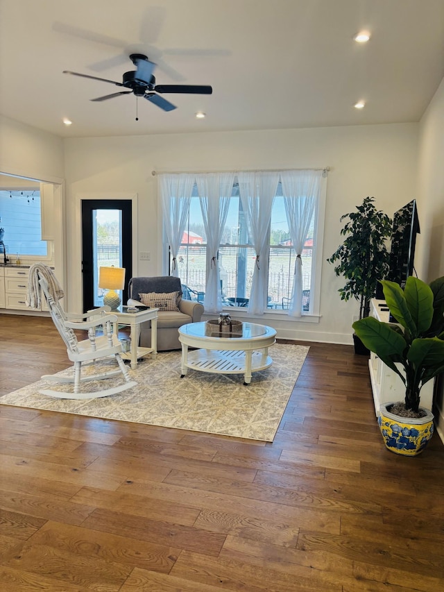 living room with a ceiling fan, baseboards, wood finished floors, and recessed lighting