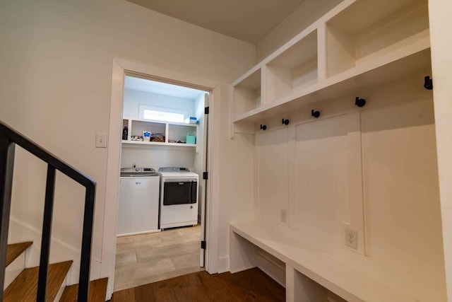 mudroom featuring wood finished floors and washer and dryer