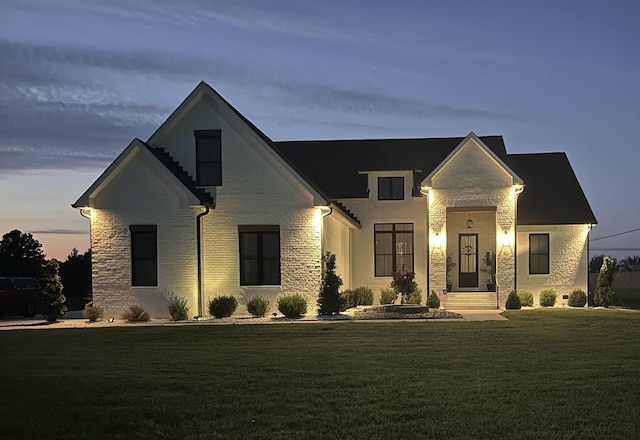 view of front of house with stone siding and a front yard