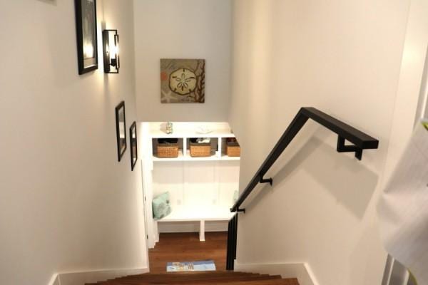 stairway with wood finished floors and baseboards