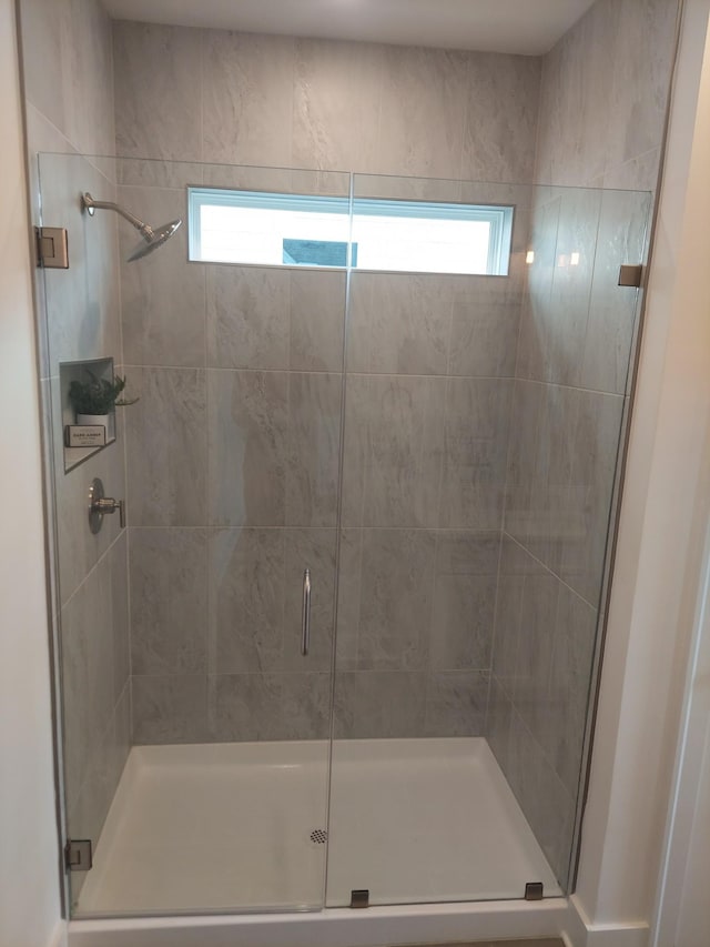 bathroom with a wealth of natural light and a stall shower