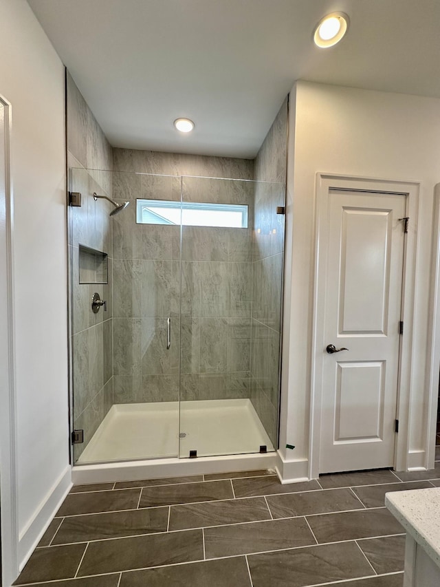 full bath featuring recessed lighting, a shower stall, vanity, and baseboards