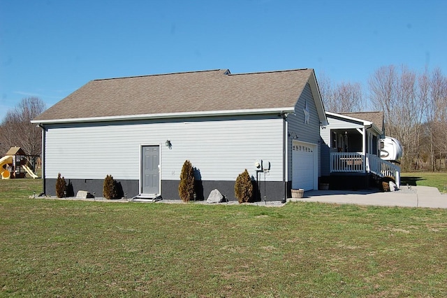 view of side of property featuring roof with shingles, a playground, a porch, concrete driveway, and a lawn