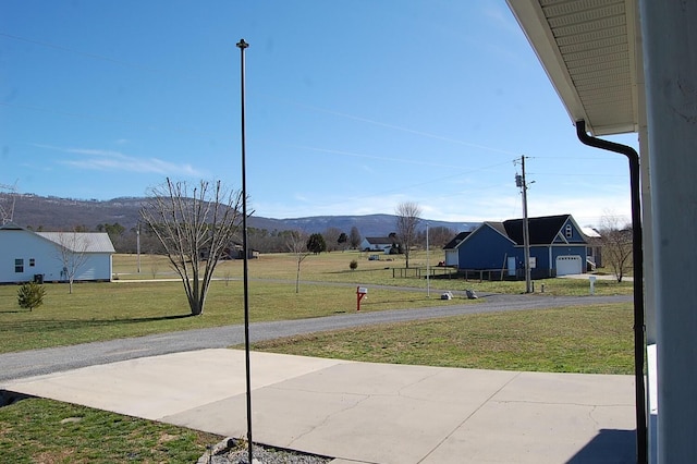 exterior space featuring driveway and a mountain view