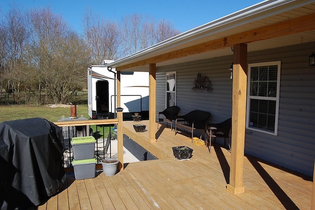 wooden terrace featuring outdoor dining area and area for grilling