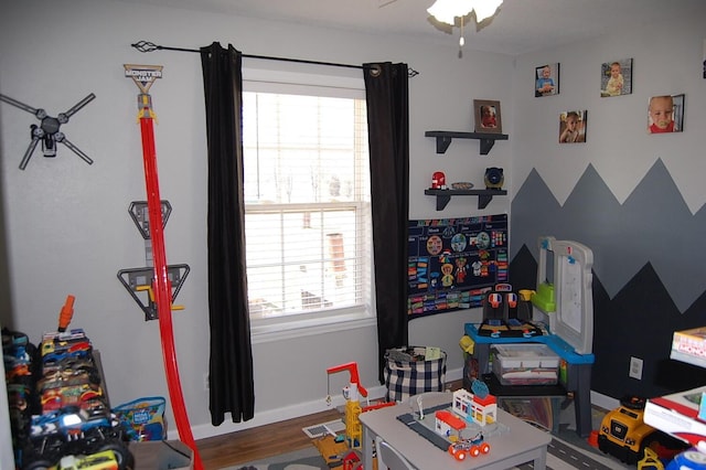 game room with visible vents, baseboards, and wood finished floors