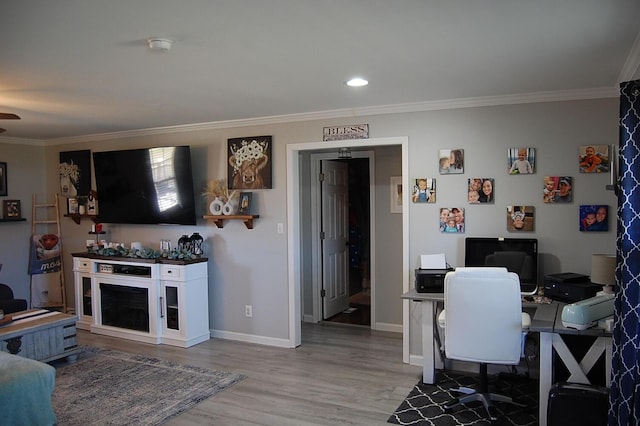 office space with baseboards, ornamental molding, recessed lighting, and light wood-style floors