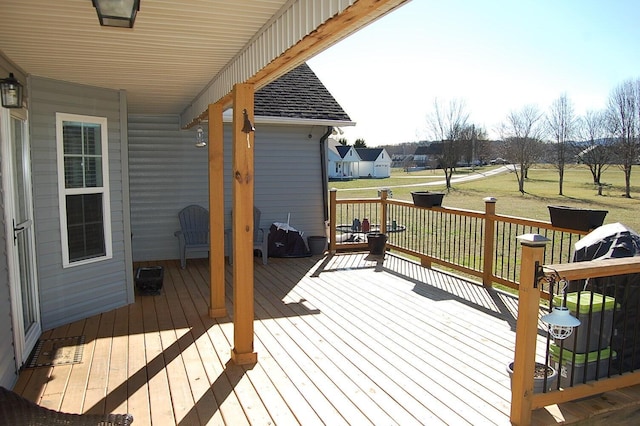 wooden terrace with a residential view and a lawn